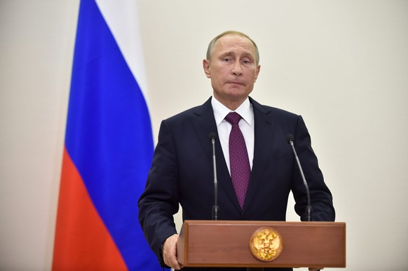 epa05592953 Russian President Vladimir Putin looks on during a press conference after a Normandy format meeting in Berlin, Germany, 20 October 2016. Vladimir Putin joined talks with German Chancellor  ...