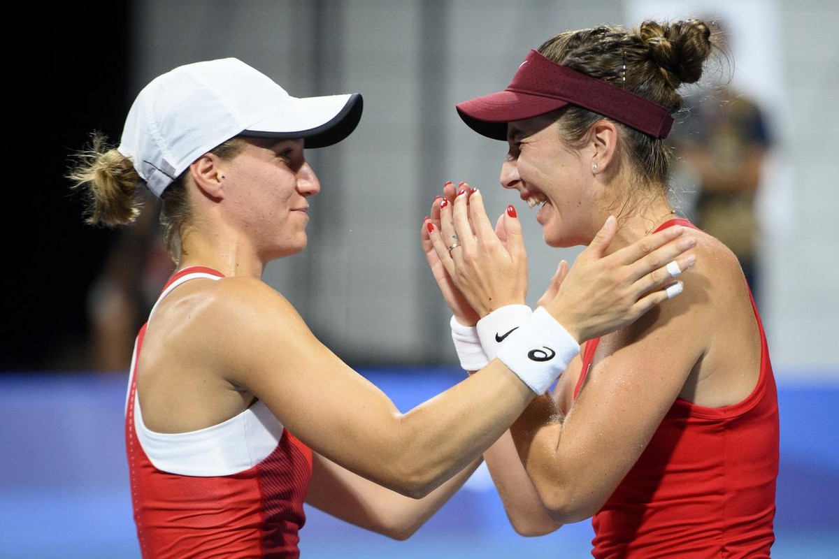 Belinda Bencic, right, and Viktorija Golubic, left, of Switzerland celebrate after winning against Laura Pigossi and Luisa Stefani of Brazil during the women's doubles tennis semifinal at the 202 ...