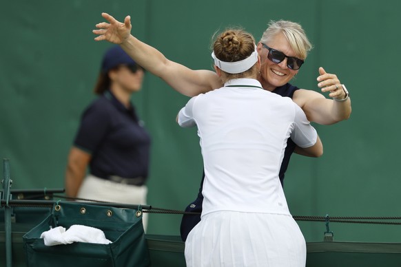 Switzerland&#039;s Celine Naef celebrates with mother and coach Sandra Huber Naef after winning her match against Dayana Yastremska of Ukraine during the third round of the Qualifying competition for  ...