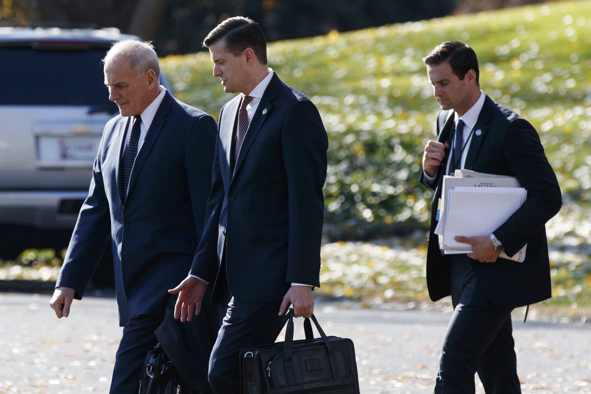 In this Nov. 29, 2017 file photo, White House Chief of Staff John Kelly, left, walks with White House staff secretary Rob Porter, center, and President Donald Trump's personal aide John McEntee t ...