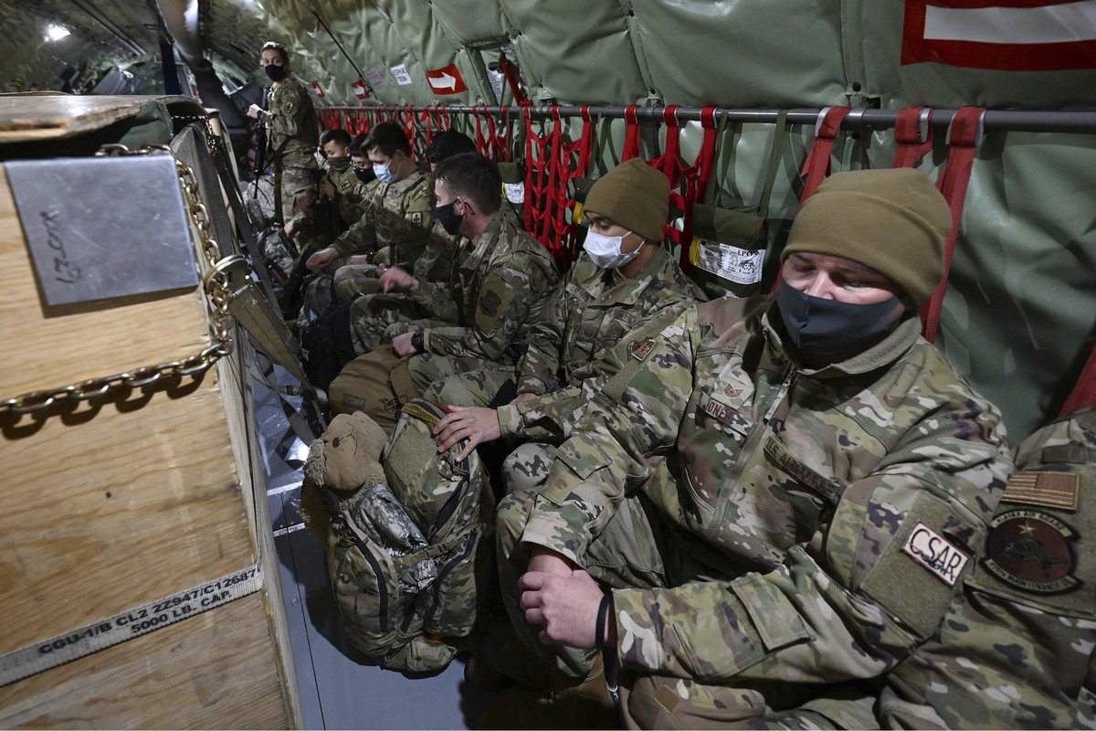 Guardsmen are seated on a KC-135 Stratotanker from the Alaska Air National Guard's 168th Wing as they prepare to depart from Joint Base Elmendorf-Richardson, Alaska, Sunday, Jan. 17, 2021, to ass ...