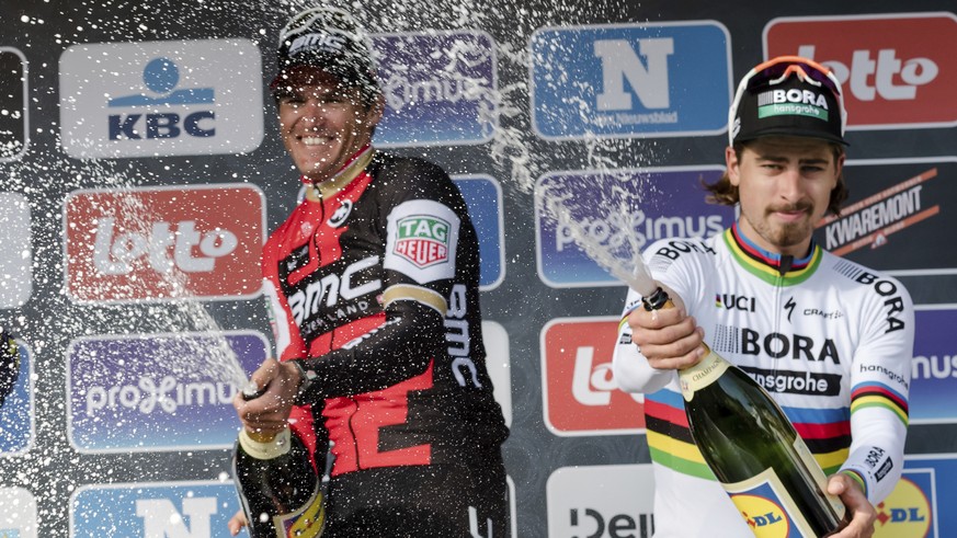 Belgium&#039;s Greg Van Avermaet of the BMC Racing Team, left, spays champagne as he stands on the podium after winning the Gent Wevelgem cycling race, in Wevelgem, Belgium on Sunday March 26, 2017. B ...