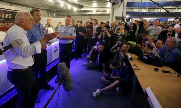 epa06006991 Chief Executive Officer (CEO) of Live Nation GSA Marek Lieberberg (L) and Police officers give a statement after evacuation of the &#039;Rock am Ring&#039; festival after a terrorist threa ...