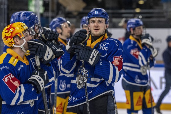 Die Spieler von Zug mit Lino Martschini, links, und Livio Stadler, mitte, reagieren nach der Niederlage beim Eishockey Meisterschaftsspiel der National League zwischen dem EV Zug und dem HC Lugano am  ...