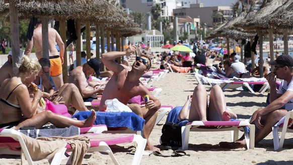 Tourists sunbathe on the beach at the Spanish Balearic Island of Mallorca, Spain, Monday, June 7, 2021. Spain is jumpstarting its summer tourism season by welcoming vaccinated visitors from most count ...