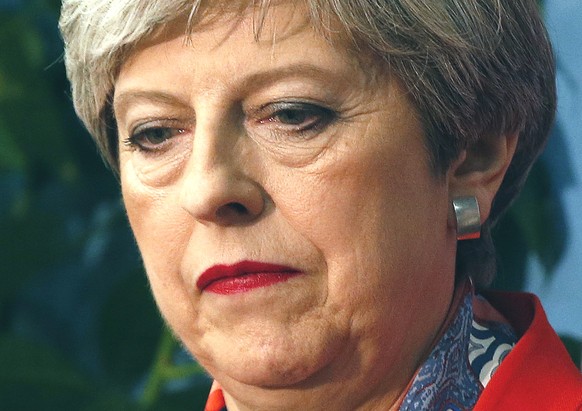 FILE In this Friday, June 9, 2017 file photo, Britain&#039;s Prime Minister Theresa May listens as the declaration at her constituency is made for in the general election in Maidenhead, England. As a  ...