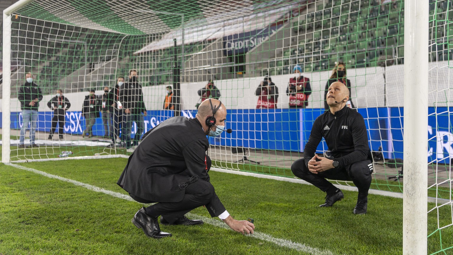 epa09103624 Officials measure the replacement goal after the original one was found to be deficient ahead of the FIFA World Cup Qatar 2022 qualifying Group C soccer match between Switzerland and Lithu ...