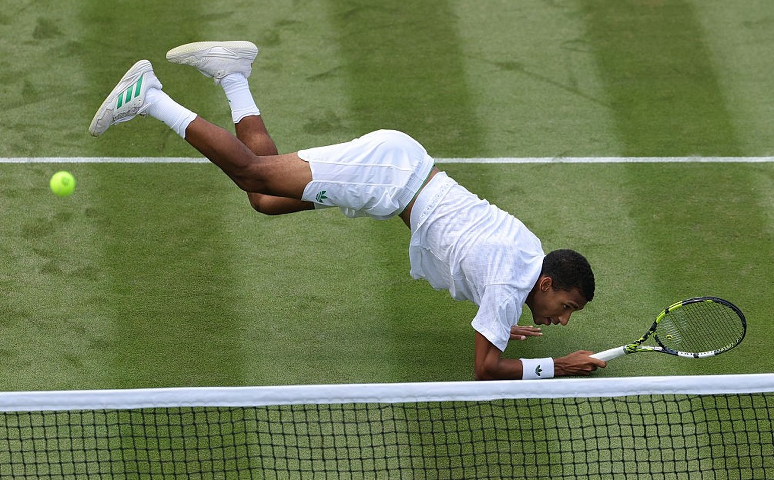 LONDON, ENGLAND - JULY 03: Felix Auger-Aliassime of Canada dives after playing a shot against Jan-Lennard Struff of Germany during the Gentlemen's Singles second round match on day three of The C ...