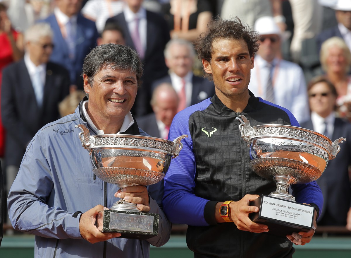 Spain's Rafael Nadal, right, poses with the special Decima cup while his oncle Toni Nadal holds the men's winner cup after the final match of the French Open tennis tournament at the Roland  ...