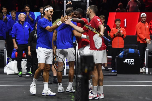 epa10202809 Team Europe double Roger Federer (L) of Switzerland and Rafael Nadal (2-L) of Spain shake hands at the net with Team World double Jack Sock (R) of the US and Frances Tiafoe of the US after ...