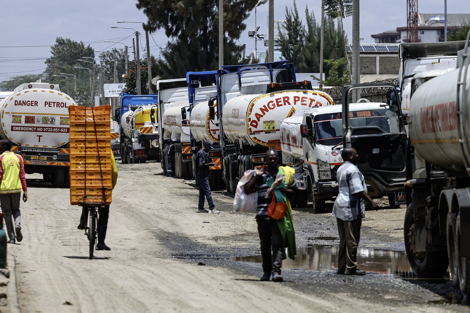 epa12848948 Fuel trucks are lined up outside the OLA Energy fuel depot, waiting to be refueled before distributing fuel to various fuel station retailers in the Industrial Area district of Nairobi, Ke ...