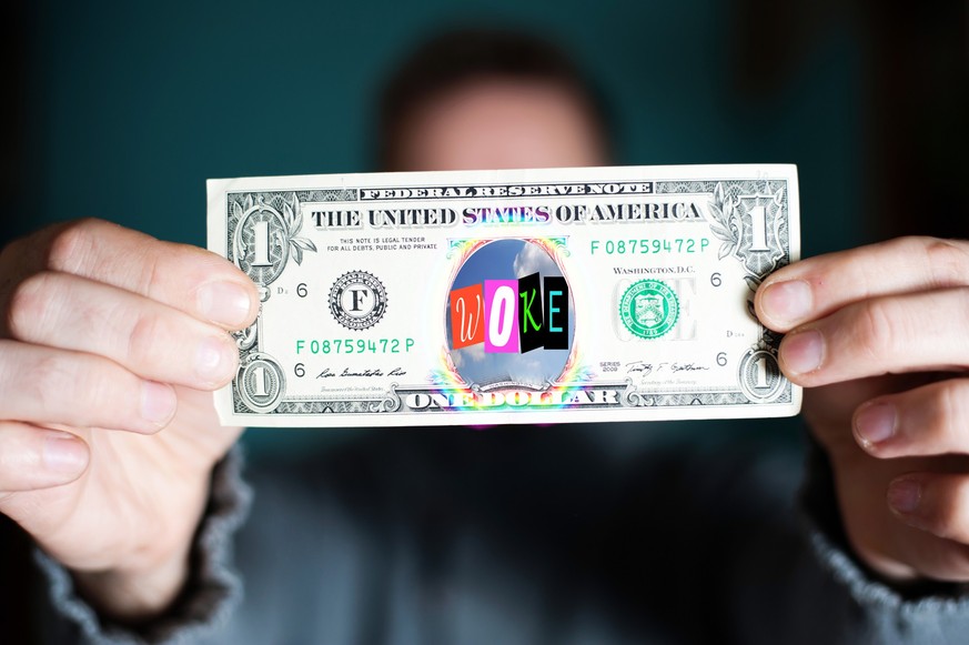 A man holds a U.S. 1 one dollar.