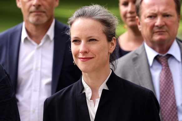 epa11561194 New Popular Front (NFP) designated candidate for prime minister Lucie Castets (C) arrives with members of the NFP leftist coalition at the meeting hosted by French president with leaders o ...