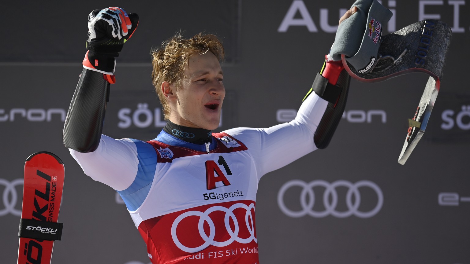 epa09543285 Marco Odermatt of Switzerland celebrates on the podium after winning the men&#039;s Giant Slalom at the FIS Alpine Skiing World Cup season opener on the Rettenbach glacier in Soelden, Aust ...