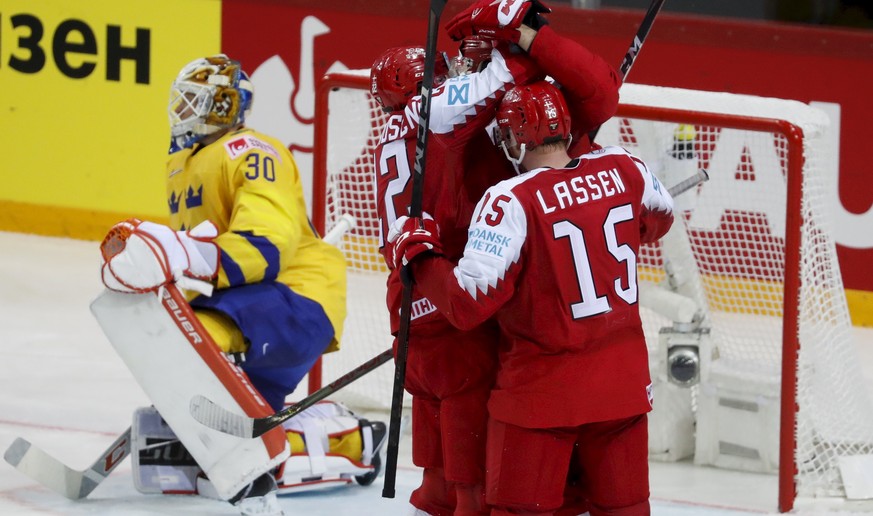 epa09219386 Players of Denmark celebrate a goal during the IIHF Ice Hockey World Championship 2021 group A match between Denmark and Sweden at the Olympic Sports Centre in Riga, Latvia, 22 May 2021. E ...