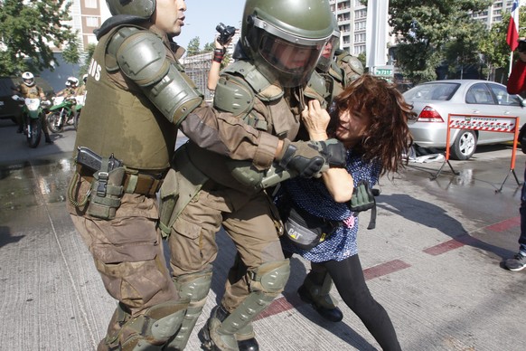 epa06443617 Members of the police arrest a woman during a demonstration against the visit of Pope Francis, in Santiago, Chile, 16 January 2018. The police dissolved in Santiago the &#039;March of the  ...