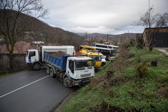 Heavy vehicles parked by local Serbs block the road in the village of Rudare, northern Kosovo on Sunday, Dec. 11, 2022. Tensions were high in northern Kosovo on Sunday, with Serbs blocking roads after ...