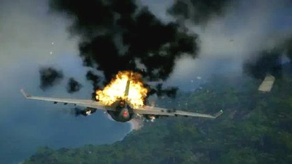Das Flugzeug fängt Feuer und bricht über der Insel in zwei Teile.