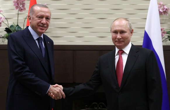 epa09495166 Russian President Vladimir Putin (R) welcomes Turkish President Recep Tayyip Erdogan during their meeting at the Bocharov Ruchei residence in Sochi, Russia, 28 September 2021. According to ...