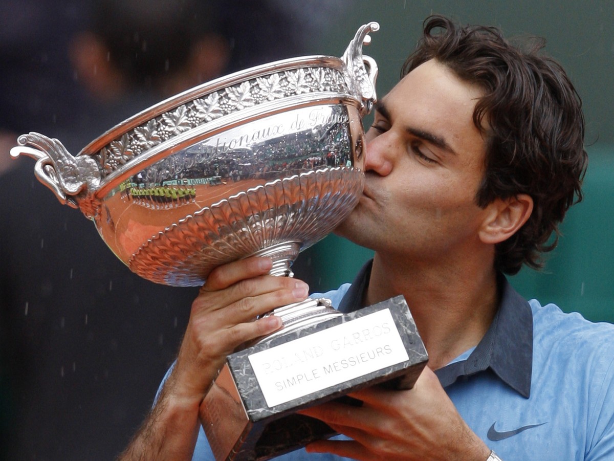 FILE - In this June 7, 2009, file photo, Switzerland's Roger Federer kisses his trophy after defeating Sweden's Robin Soderling in their men's singles final match of the French Open ten ...