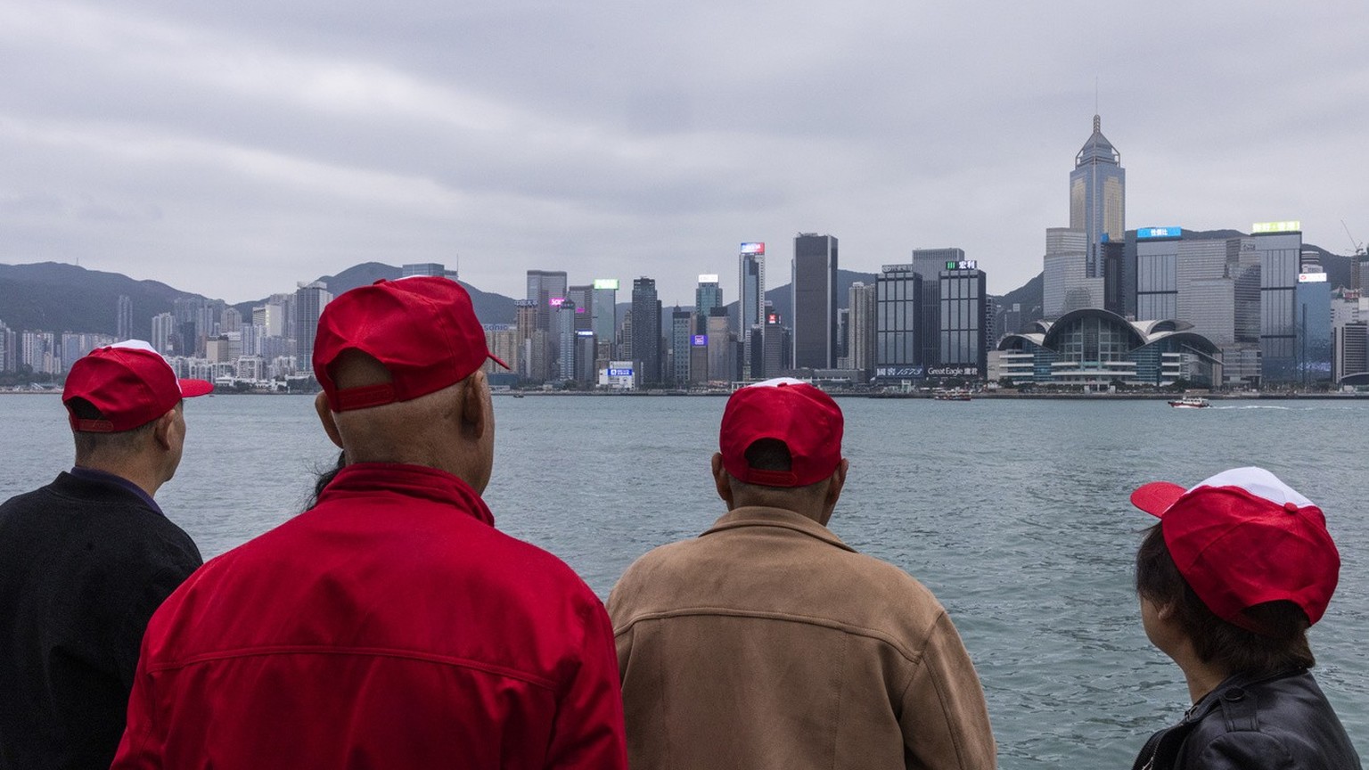 Mainland Chinese tourists tour along a promenade in Hong Kong, Monday, April 10, 2023. (AP Photo/Louise Delmotte)