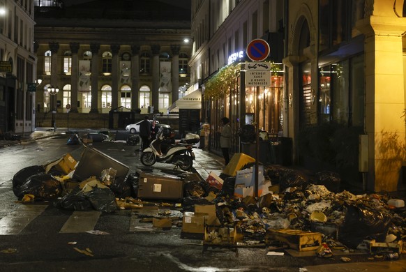 Uncollected garbage who was set on fire is pictured in a street of in Paris, Thursday, march 23, 2023. French unions are holding their first mass demonstrations Thursday since President Emmanuel Macro ...