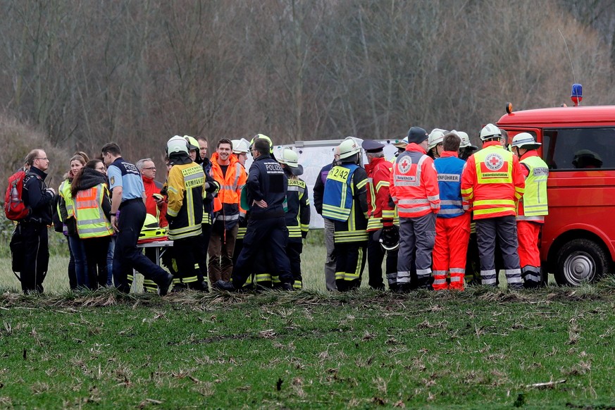 epa06468119 Firefighters and rescue personnel seen at the site of the crash after a light aircraft and a helicopter collided mid-air near Philippsburg, Germany, 23 January 2018. Both machines crashed  ...