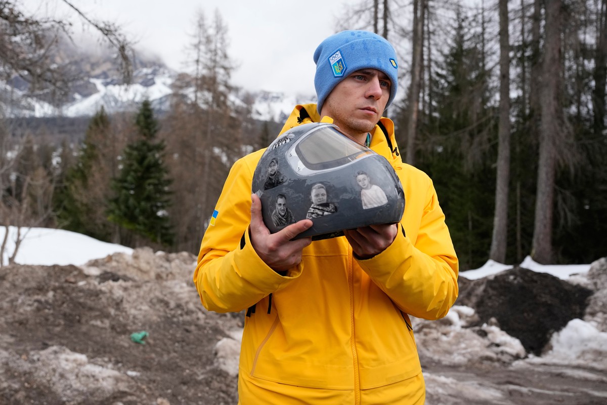 Ukrainian skeleton athlete Vladyslav Heraskevych holds his crash helmet as he stands outside the sliding center at the 2026 Winter Olympics, in Cortina d'Ampezzo, Italy, Thursday, Feb. 12, 2026.  ...