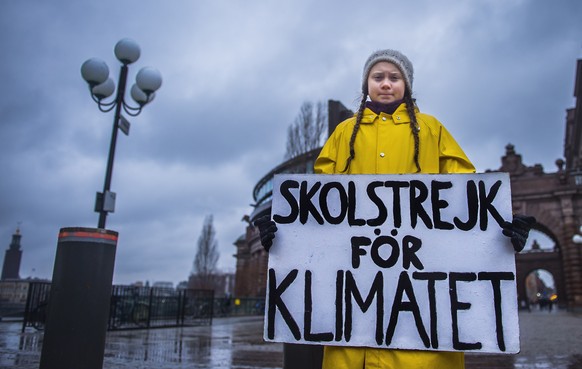 epa07199174 Swedish 15-year-old girl Greta Thunberg holds a placard reading &#039;School strike for the climate&#039;, during a protest against climate change outside the Swedish parliament in Stockho ...