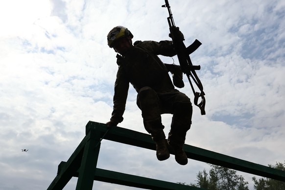 In this photo provided by Ukraine's 65th Mechanized Brigade press service, a soldier practices military skills at a training ground near the frontline in the Zaporizhzhia region, Ukraine, Friday, ...