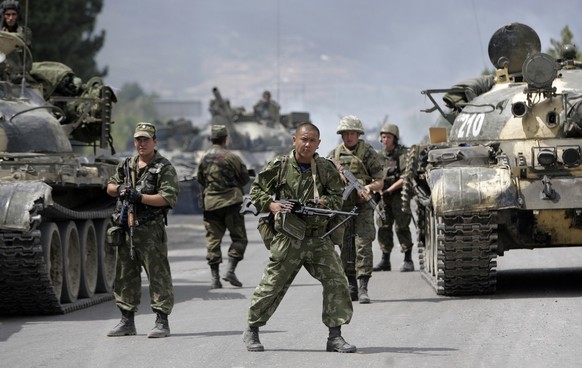 FILE- In this file photo taken on Thursday, Aug. 14, 2008, Russian soldiers block the road on the outskirts of Gori, northwest of the capital Tbilisi, Georgia. Russia's Prime Minister Dmitry Medv ...