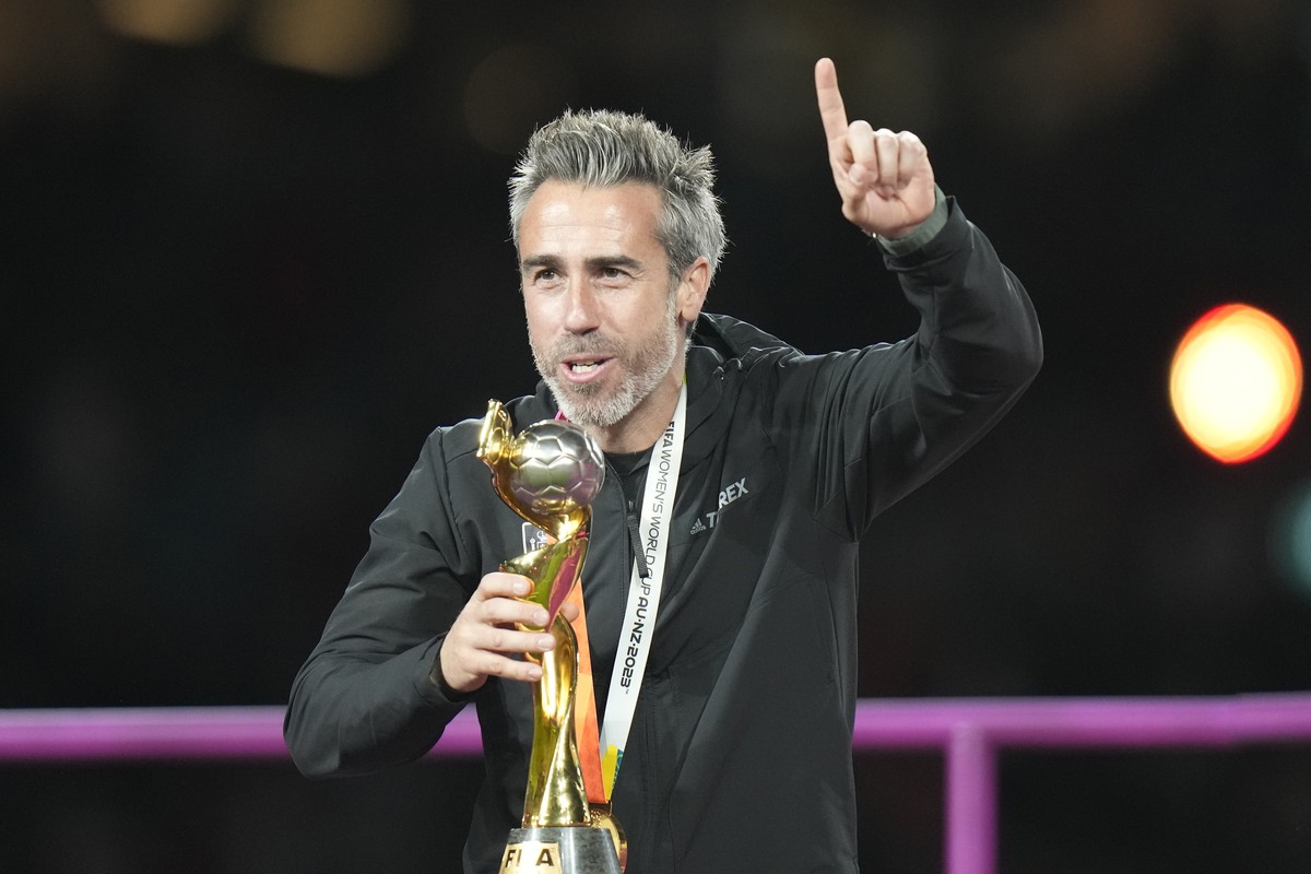 Spain's head coach Jorge Vilda celebrates with trophy after winning the Women's World Cup soccer final against England at Stadium Australia in Sydney, Australia, Sunday, Aug. 20, 2023. (AP P ...
