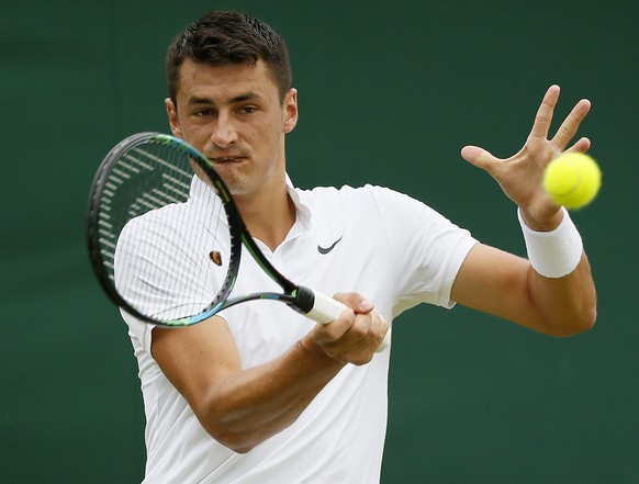 Bernard Tomic of Australia hits a shot during his match against Pierre-Hugues Herbert of France at the Wimbledon Tennis Championships in London, July 1, 2015. REUTERS/Stefan Wermuth