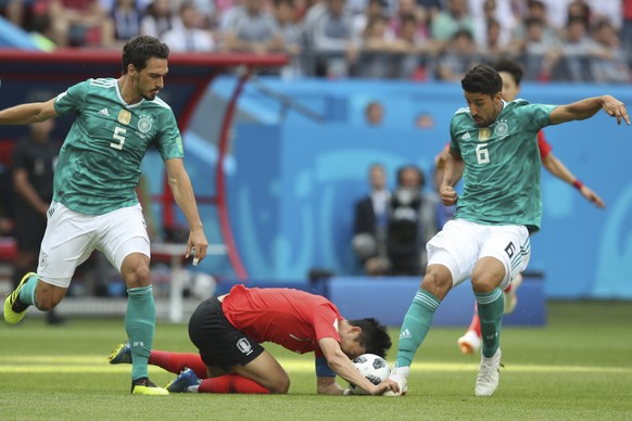 South Korea&#039;s Son Heung-min, center, is tackled by Germany&#039;s Mats Hummels, left, and Germany&#039;s Sami Khedira during the group F match between South Korea and Germany, at the 2018 soccer  ...