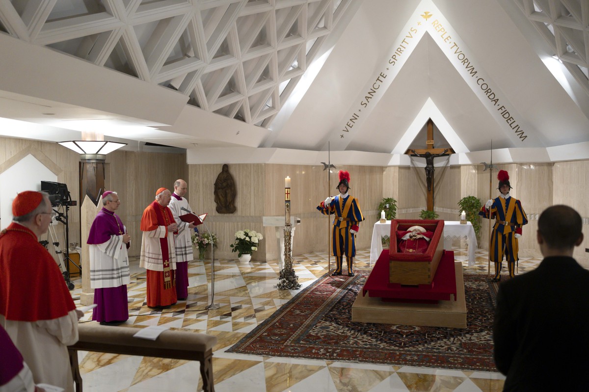 Pope Francis's body is laid out in state inside his private chapel at the Vatican, Monday, April 21, 2025. From left, Secretary of State Pietro Parolin, Master of Ceremonies Archbishop Diego Giov ...
