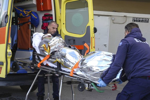 Paramedics transfer a shipwreck survivor to a hospital on the northeastern island of Lesbos in the Aegean Sea, Greece, Sunday, November 26, 2023. A cargo ship sank early off the coast of the Greek island of Lesbos...