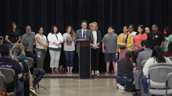 Families of the victims of the Uvalde elementary school shooting stand with attorney Josh Koskoff, center, during a news conference, Wednesday, May 22, 2024, in Uvalde, Texas. The families of 19 of th ...