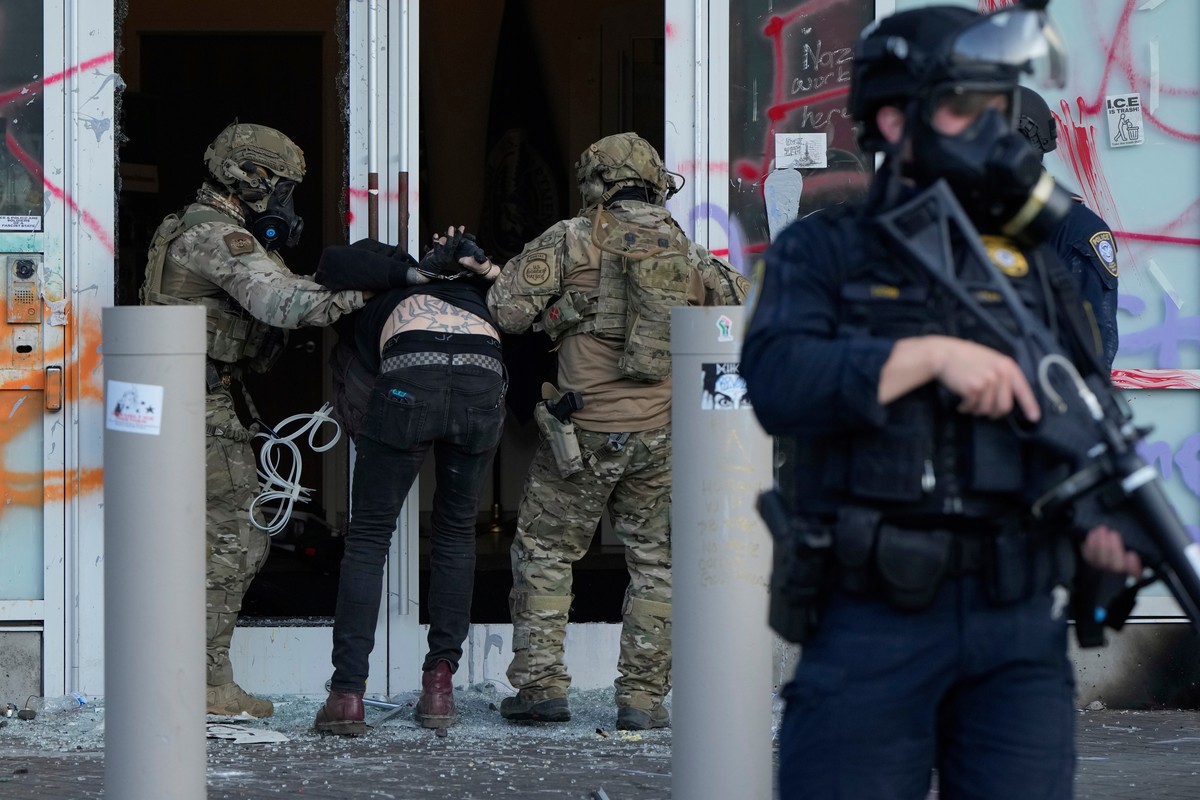 FILE - U.S. Customs and Border Protection agents detain a man outside the U.S. Immigration and Customs building during a protest in Portland, Ore., June 14, 2025. (AP Photo/Jenny Kane, File)
Trump Mil ...