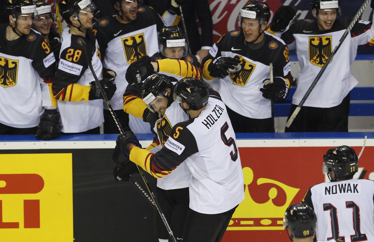 Germany's Leon Draisaitl, center left, celebrates with teammates after scoring his sides third goal during the Ice Hockey World Championships group A match between the United States and Great Bri ...