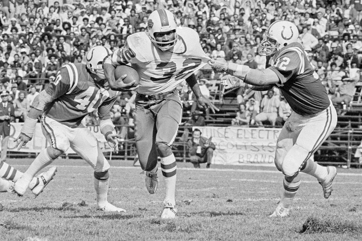 FILE - Buffalo Bulls running back O.J. Simpson (32) has his jersey pulled by Baltimore Colts linebacker Mike Curtis, during the second quarter of an NFL football game in Baltimore, Md., Oct. 12, 1975. ...