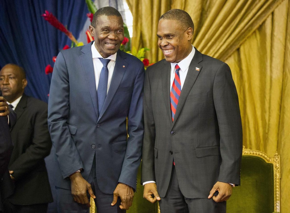 Haiti's new prime minister Jean-Henry Ceant, right, talks to Senate President Joseph Lambert during the nomination ceremony at the national Palace in Port-au-Prince, Haiti, Tuesday, Aug. 7, 2018. ...