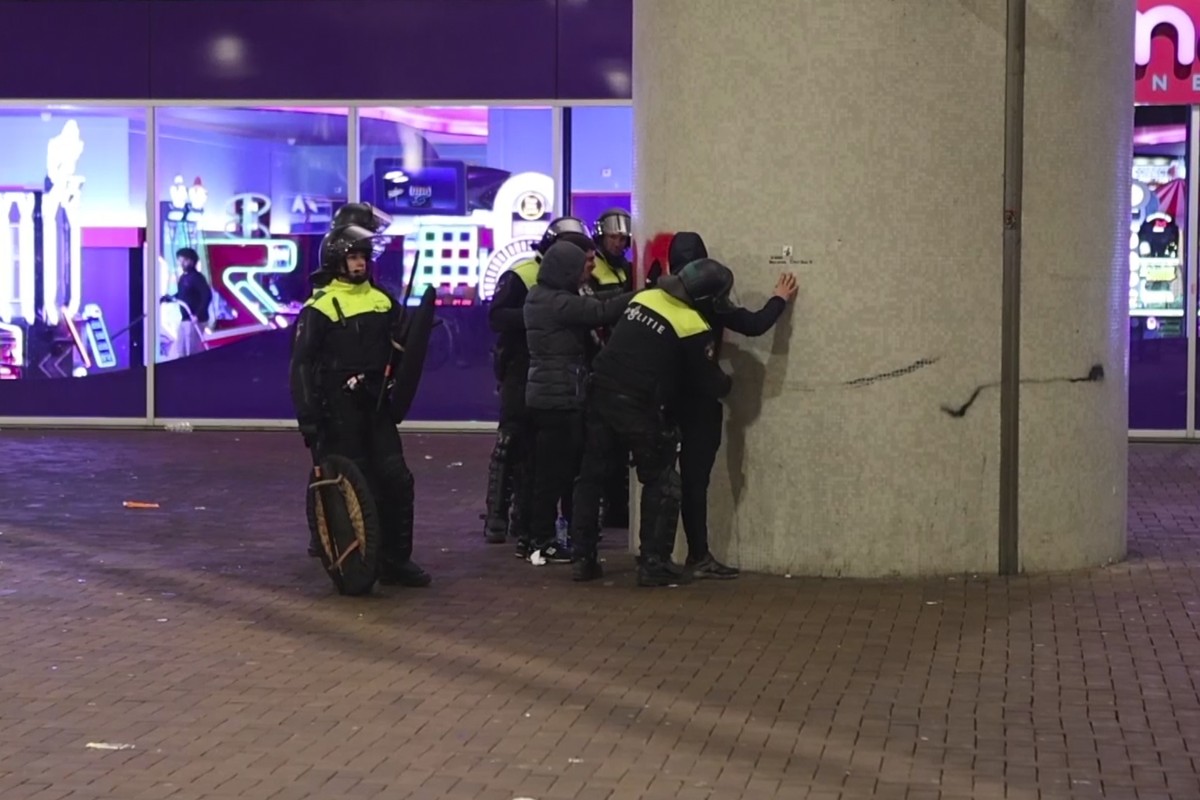 In this image taken from video, police frisk pro-Palestinian supporters near the Ajax stadium in Amsterdam, the Netherlands, Thursday, Nov. 7, 2024. (AP Photo InterVision)