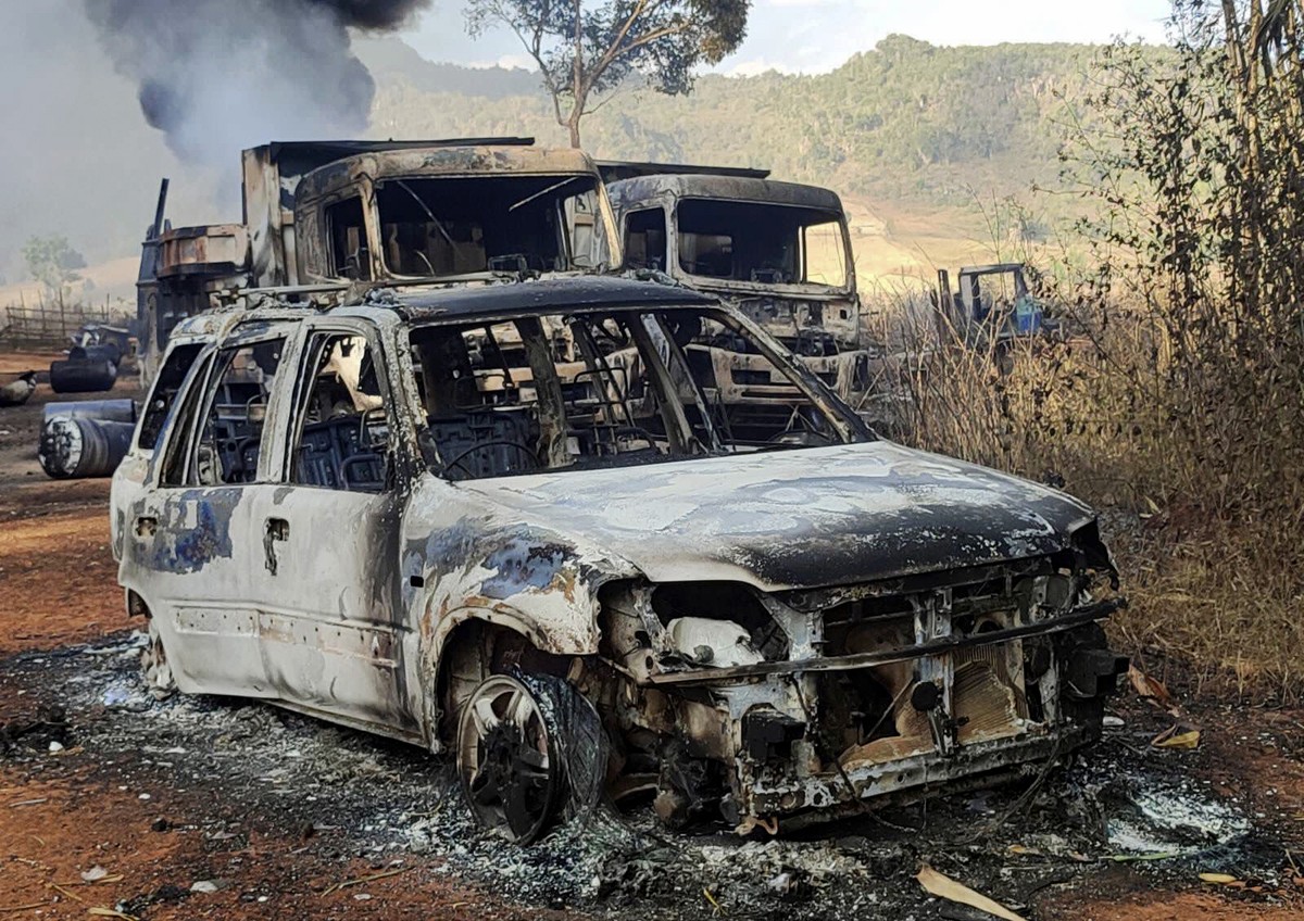 In this photo provided by the Karenni Nationalities Defense Force (KNDF), vehicles smolder in Hpruso township, Kayah state, Myanmar, Friday, Dec. 24, 2021. Myanmar government troops rounded up village ...