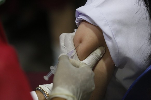 epa12311437 A health worker from the community health center carries out a cervical cancer and rubella vaccination for a Banda Aceh Methodist School student in Banda Aceh, Indonesia, 20 August 2025. C ...