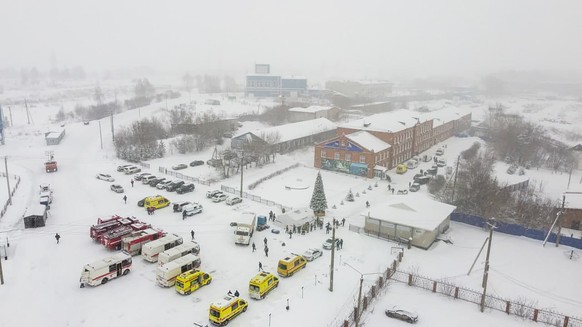 Ambulances and fire trucks are parked near the Listvyazhnaya coal mine out of the Siberian city of Kemerovo, about 3,000 kilometres (1,900 miles) east of Moscow, Russia, Thursday, Nov. 25, 2021. A fir ...