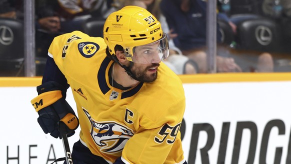Nashville Predators defenseman Roman Josi (59) skates with the puck during the second period of an NHL preseason hockey game, Saturday, Oct. 5, 2024, in Nashville, Tenn. (AP Photo/Johnnie Izquierdo)