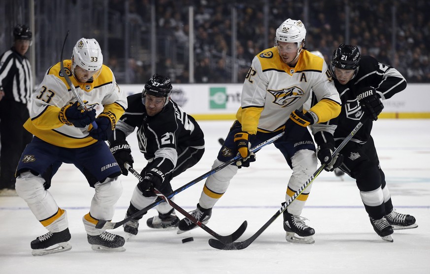 Nashville Predators left wing Viktor Arvidsson (33), of Sweden, and center Ryan Johansen (92) battle Los Angeles Kings defenseman Alec Martinez (27) and center Nick Shore (21) for the puck during the  ...