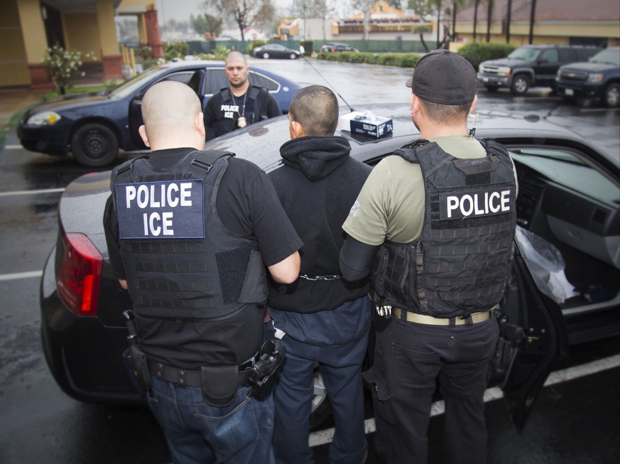 In this photo taken Feb. 7, 2017, released by U.S. Immigration and Customs Enforcement, an arrest is made during a targeted enforcement operation conducted by U.S. Immigration and Customs Enforcement  ...