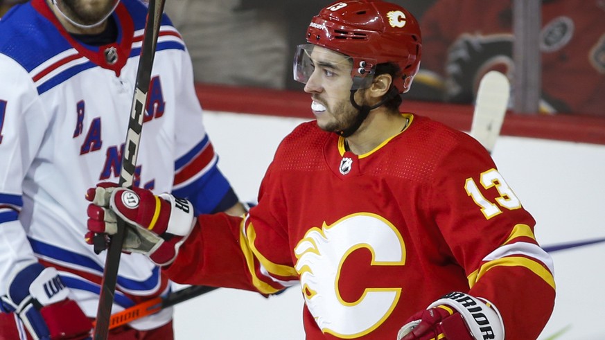 New York Rangers&#039; Barclay Goodrow, left, looks on as Calgary Flames&#039; Johnny Gaudreau celebrates his goal during the second period of an NHL hockey game Saturday, Nov. 6, 2021, in Calgary, Al ...