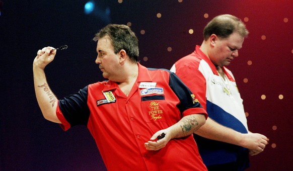 Phil Taylor (L), PDC world champion in action during his match against Dutch BDF world champion Raymond van Barneveld (R) during the Master of Darts tournament in Hengelo, Netherlands on Thursday 10 F ...